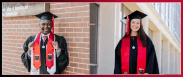 Two graduates stand in front of Grady college in their caps and gowns.