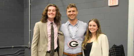 Two students and their instructor pose for a picture.